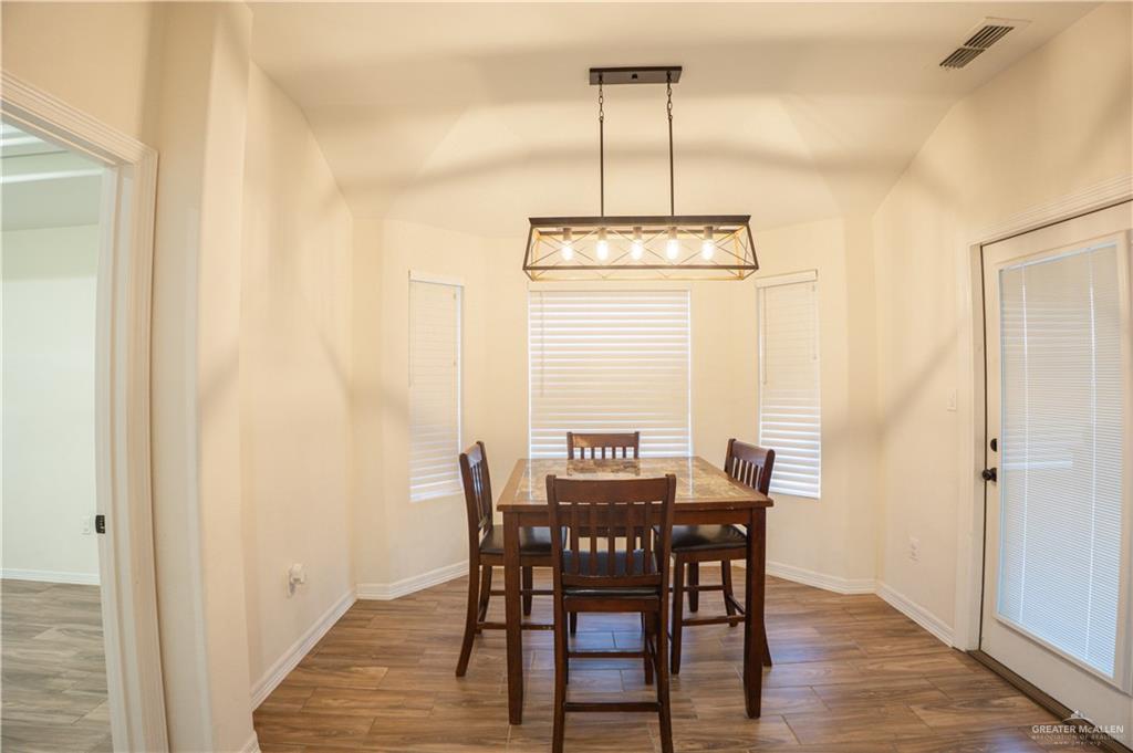8725 Spoonbill Street Harlingen, TX 78552 - Photo 6 of 18 a view of a dining room with furniture window and wooden floor