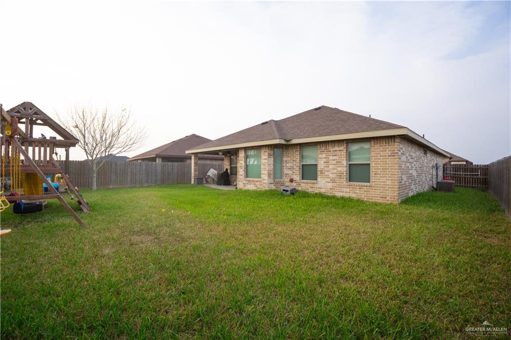 8725 Spoonbill Street Harlingen, TX 78552 - Photo 8 of 18 a view of a house with a backyard