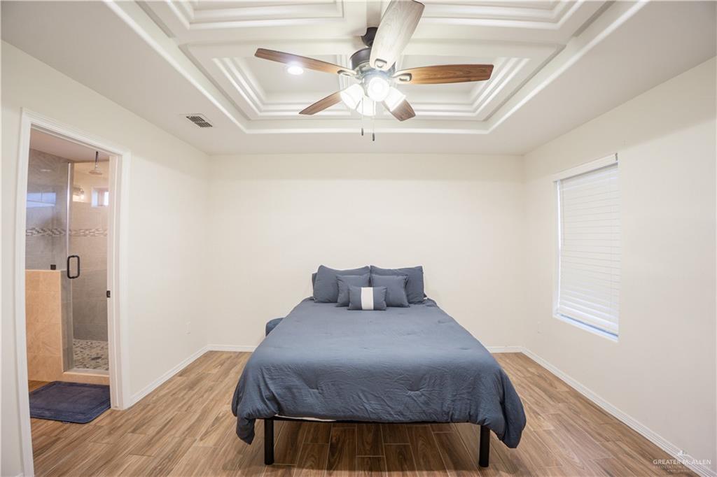 8725 Spoonbill Street Harlingen, TX 78552 - Photo 10 of 18 a bedroom with a bed and wooden floor