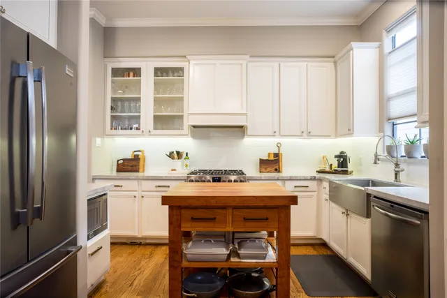 a kitchen with a stove a sink and a refrigerator