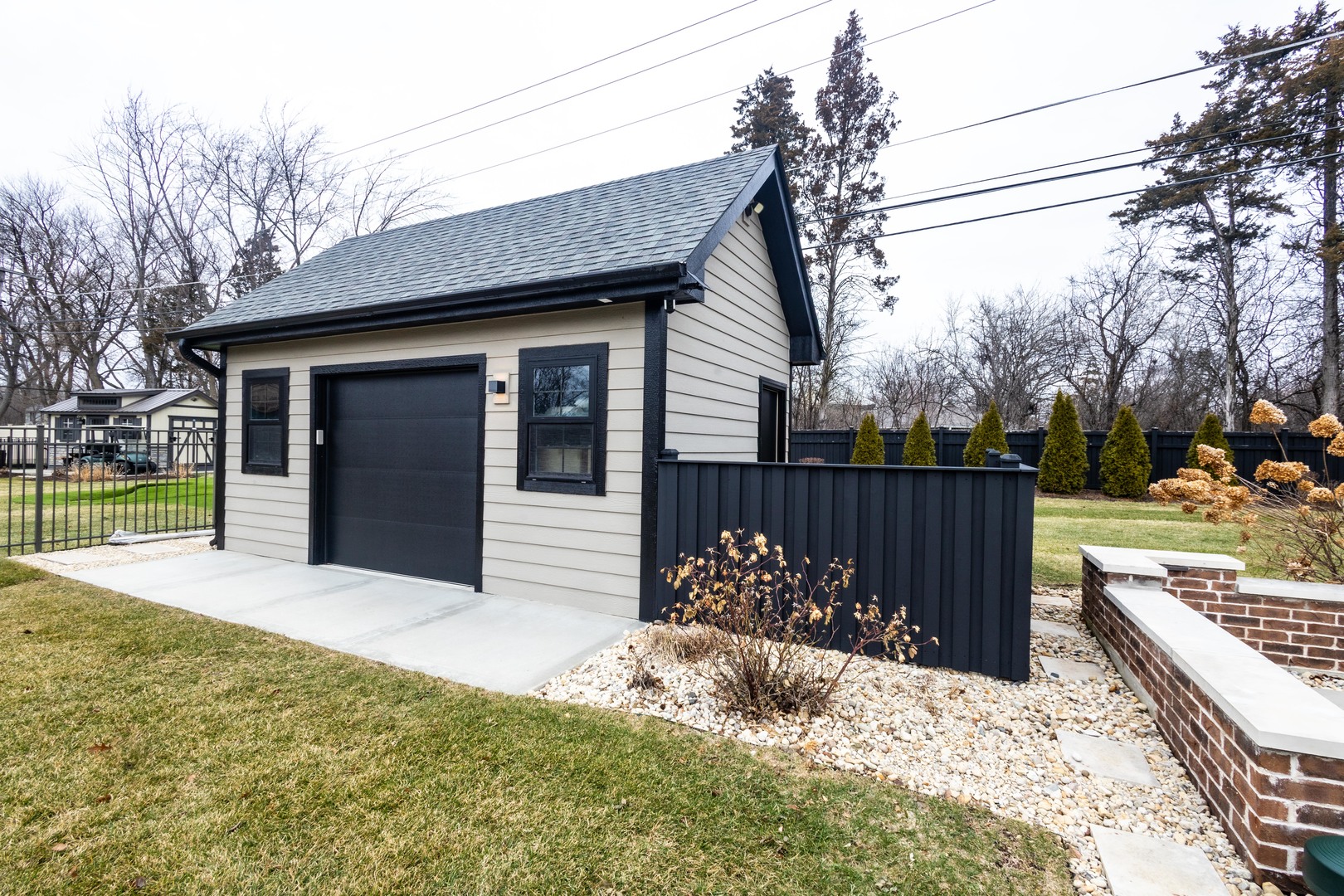740 67th Place Willowbrook, IL 60527 - Photo 23 of 47 a view of a house with a wooden fence and a floor to ceiling window
