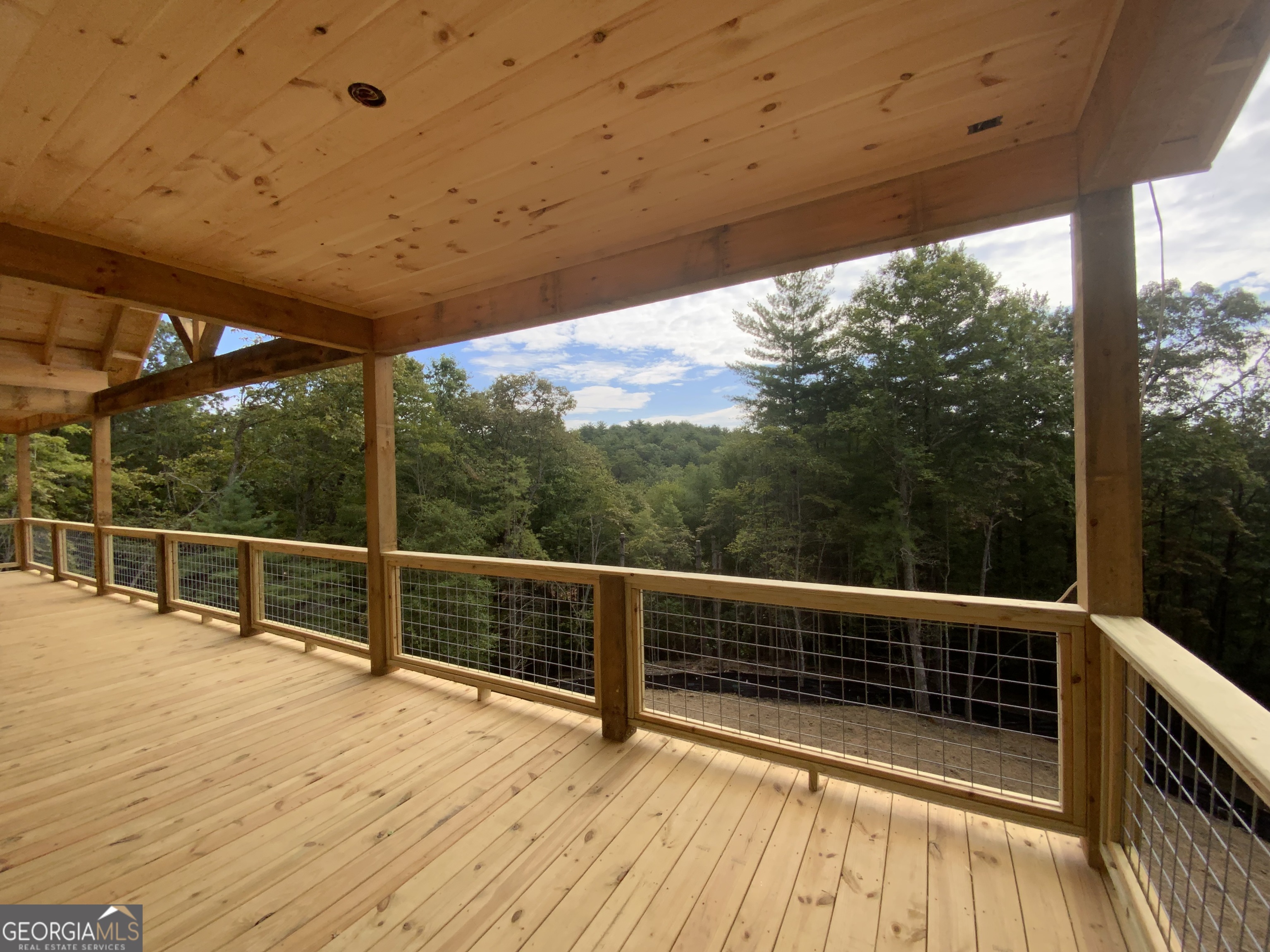 232 Red Tail Lane Morganton, GA 30560 - Photo 11 of 13 a view of a balcony with floor to ceiling window wooden floor