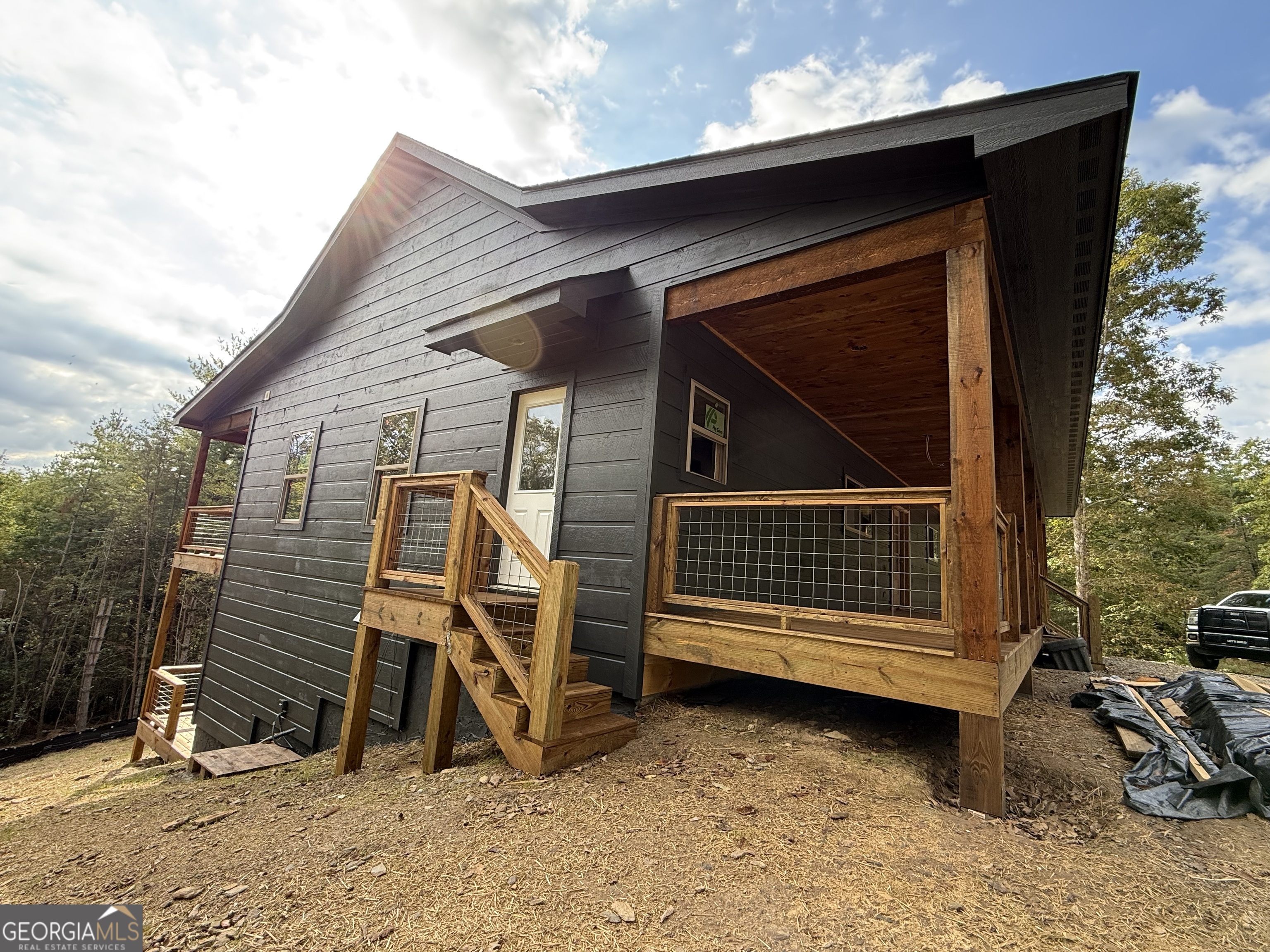 232 Red Tail Lane Morganton, GA 30560 - Photo 3 of 13 a view of a house with a yard and wooden fence