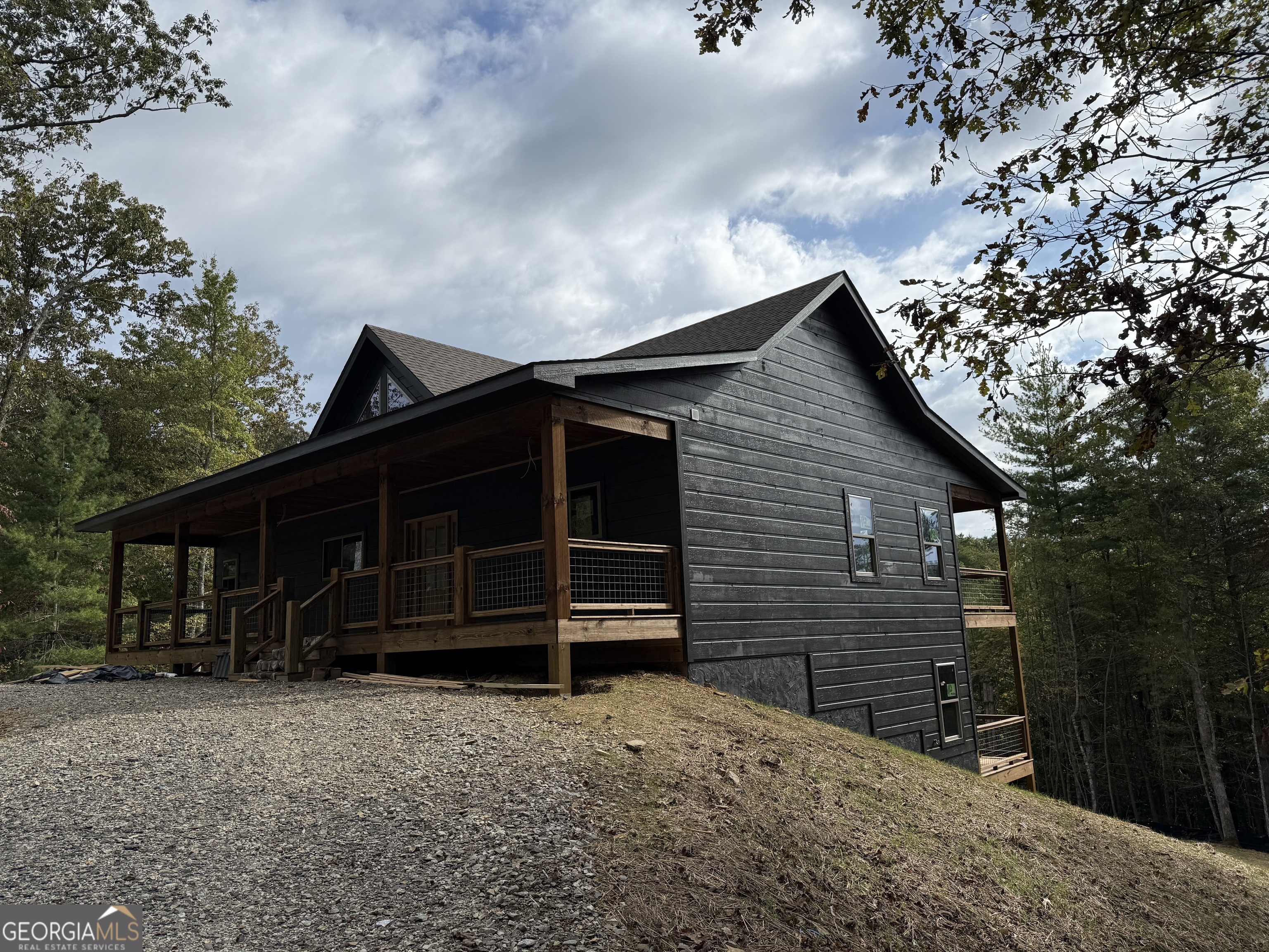 232 Red Tail Lane Morganton, GA 30560 - Photo 4 of 13 a backyard of a house with barbeque oven and trees