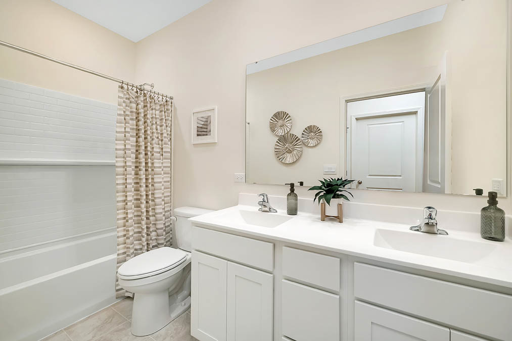 1122 Bluebell Lane Bartlett, IL 60103 - Photo 11 of 15 a bathroom with a toilet a sink a mirror a shower and vanity