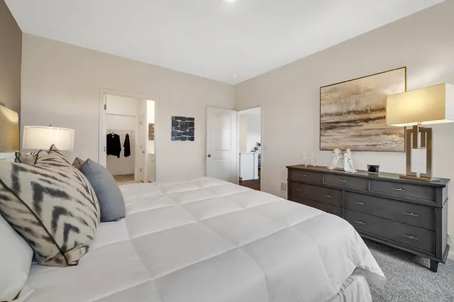 a bedroom with a bed and a lamp