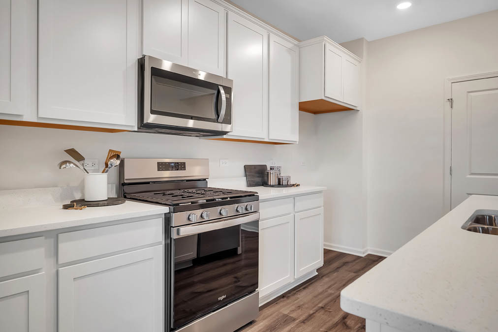1122 Bluebell Lane Bartlett, IL 60103 - Photo 5 of 15 a kitchen with stainless steel appliances granite countertop a sink a stove and microwave