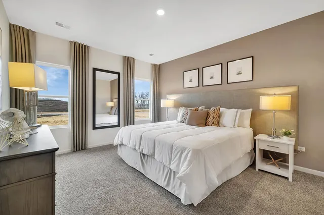 a bedroom with a large bed and a window