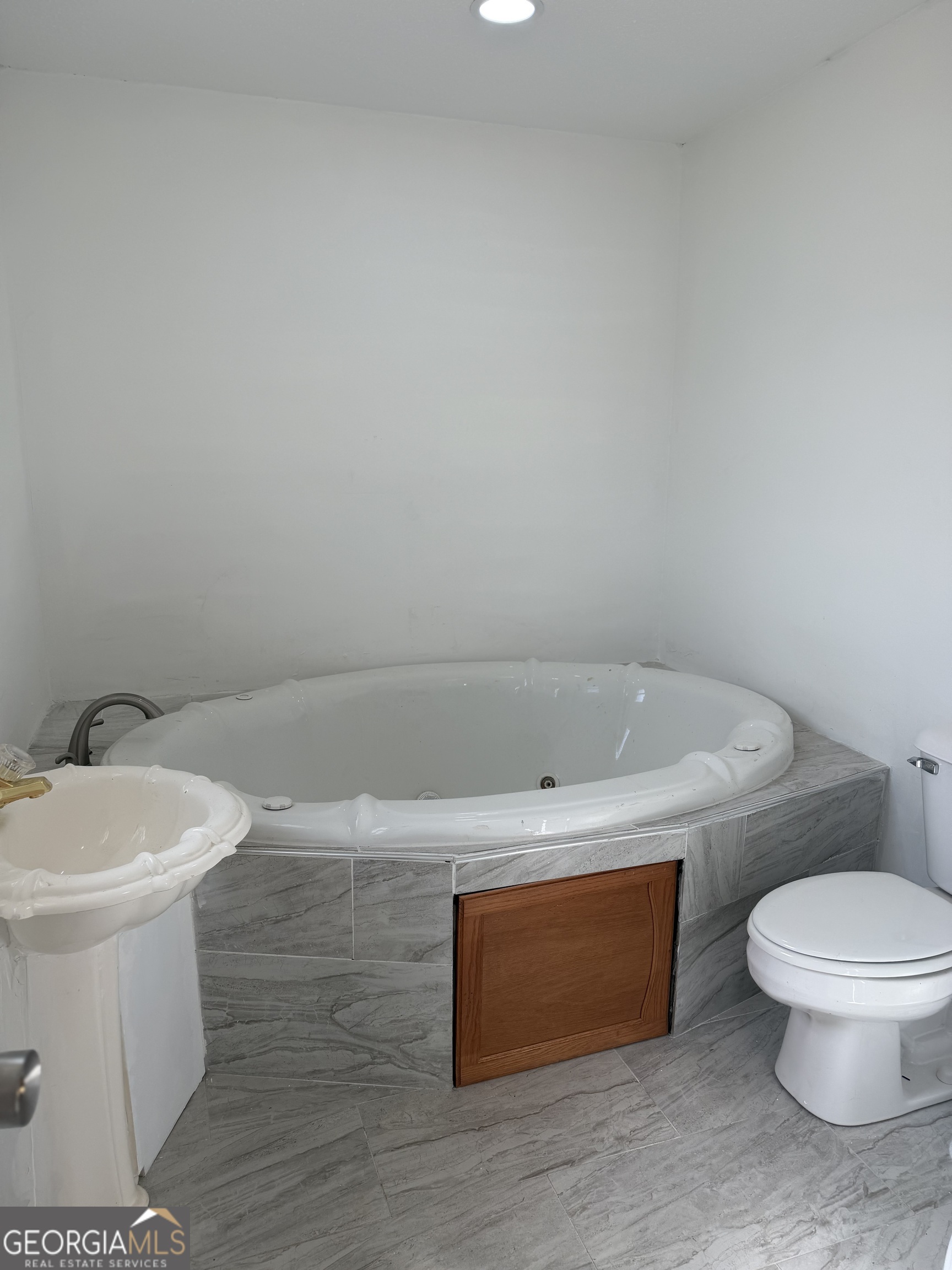 153 Wheehaw Road Macon, GA 31211 - Photo 18 of 28 a white toilet sitting next to a white tub