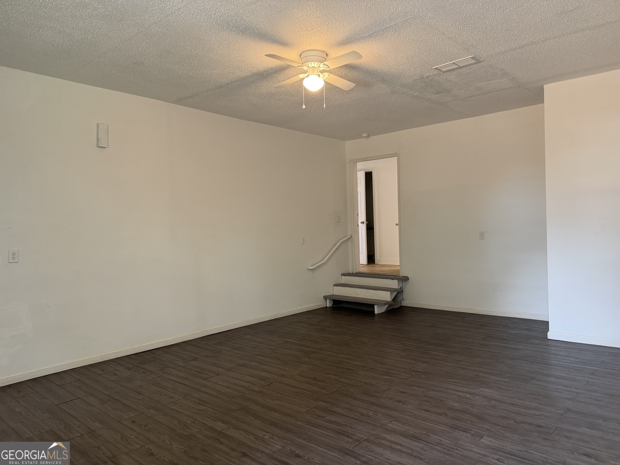 153 Wheehaw Road Macon, GA 31211 - Photo 23 of 28 a view of a room with wooden floor and a ceiling fan