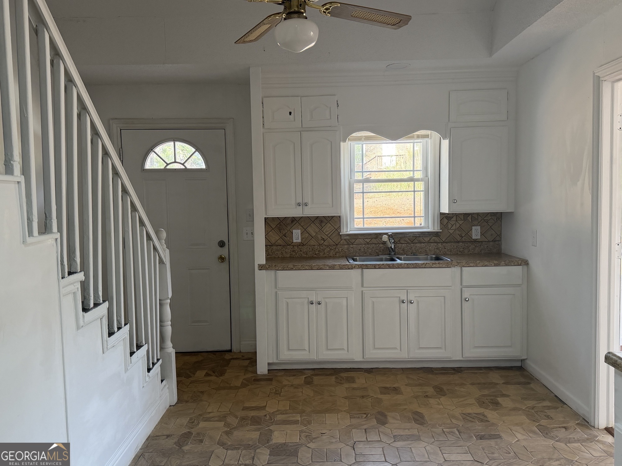 153 Wheehaw Road Macon, GA 31211 - Photo 6 of 28 a bathroom with a granite countertop sink a mirror and a window