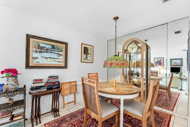 a view of a dining room with furniture and a chandelier