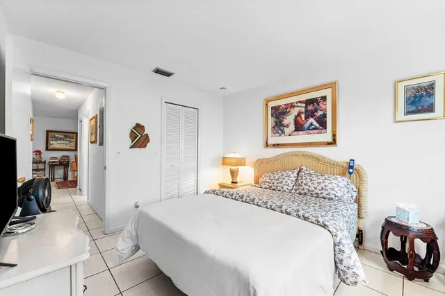 a bedroom with a bed and cabinets