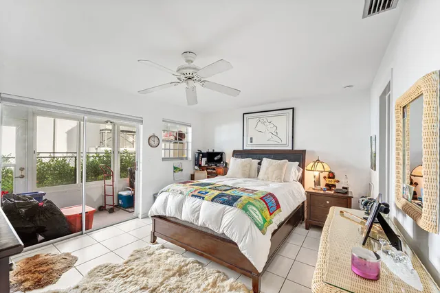 a bedroom with a bed a couch and a window