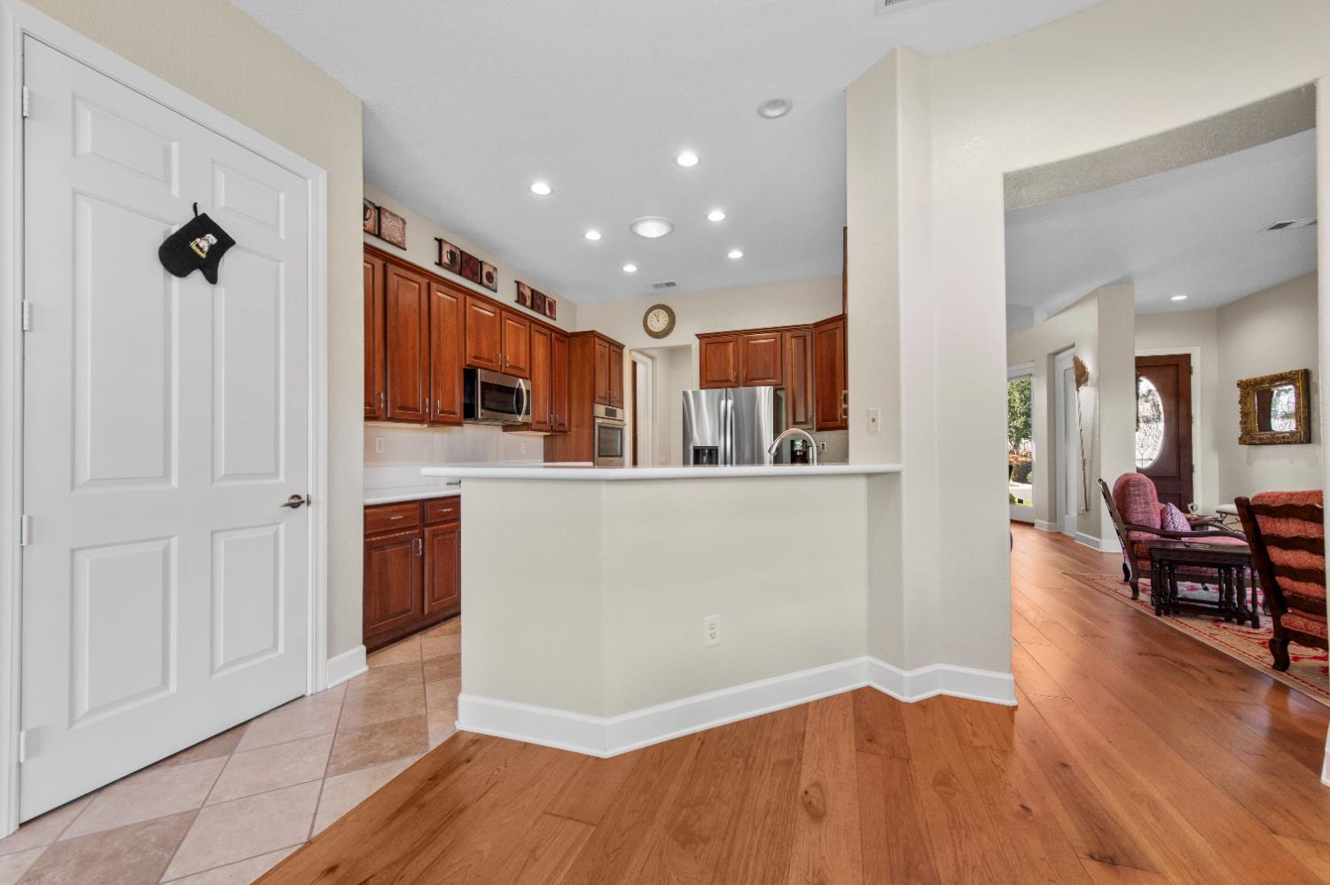 1146 Secret Lake Loop Lincoln, CA 95648 - Photo 22 of 61 a living room with stainless steel appliances kitchen island granite countertop wooden floor and a view of kitchen