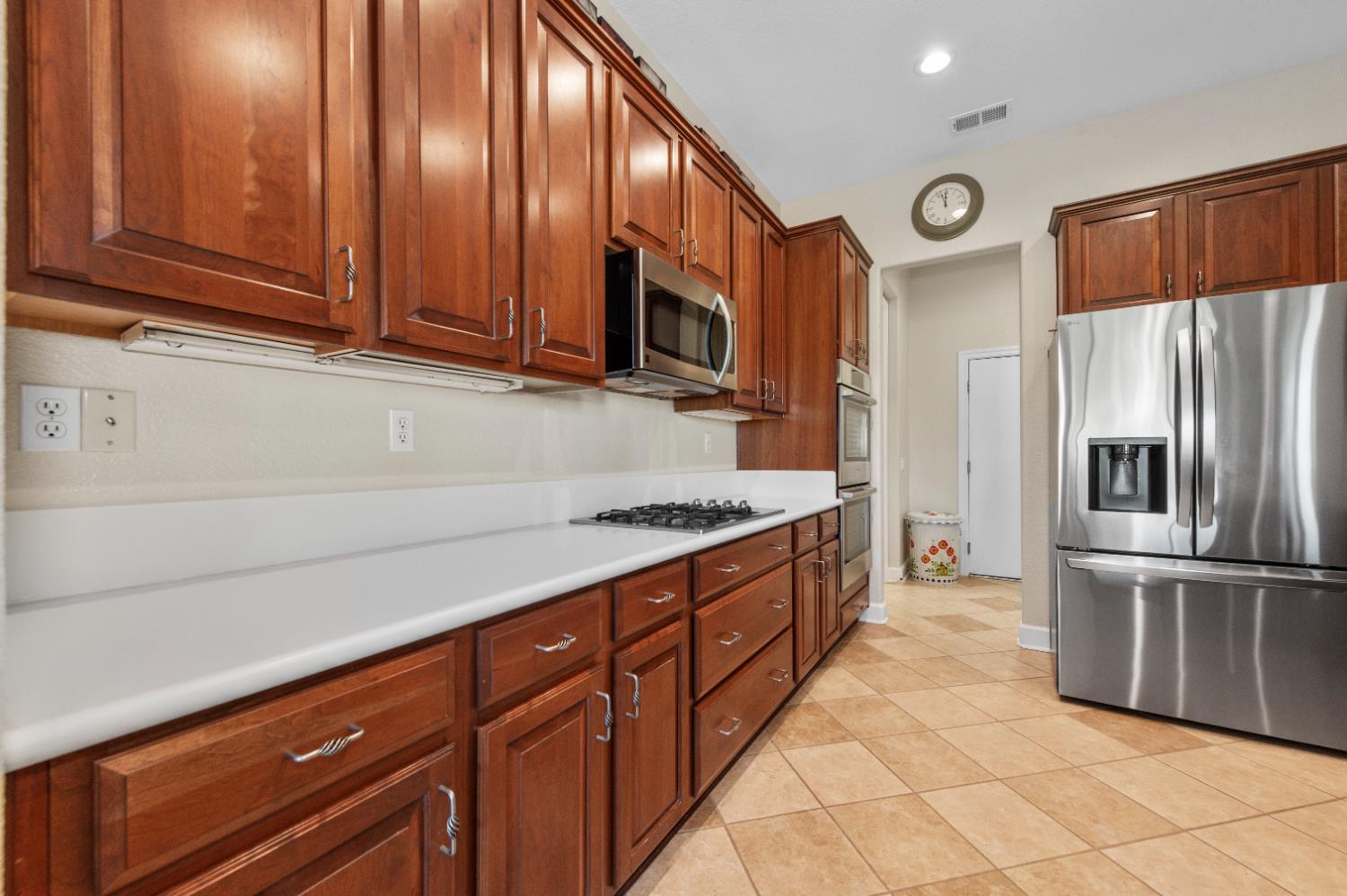 1146 Secret Lake Loop Lincoln, CA 95648 - Photo 23 of 61 a kitchen with stainless steel appliances granite countertop a refrigerator and a stove top oven