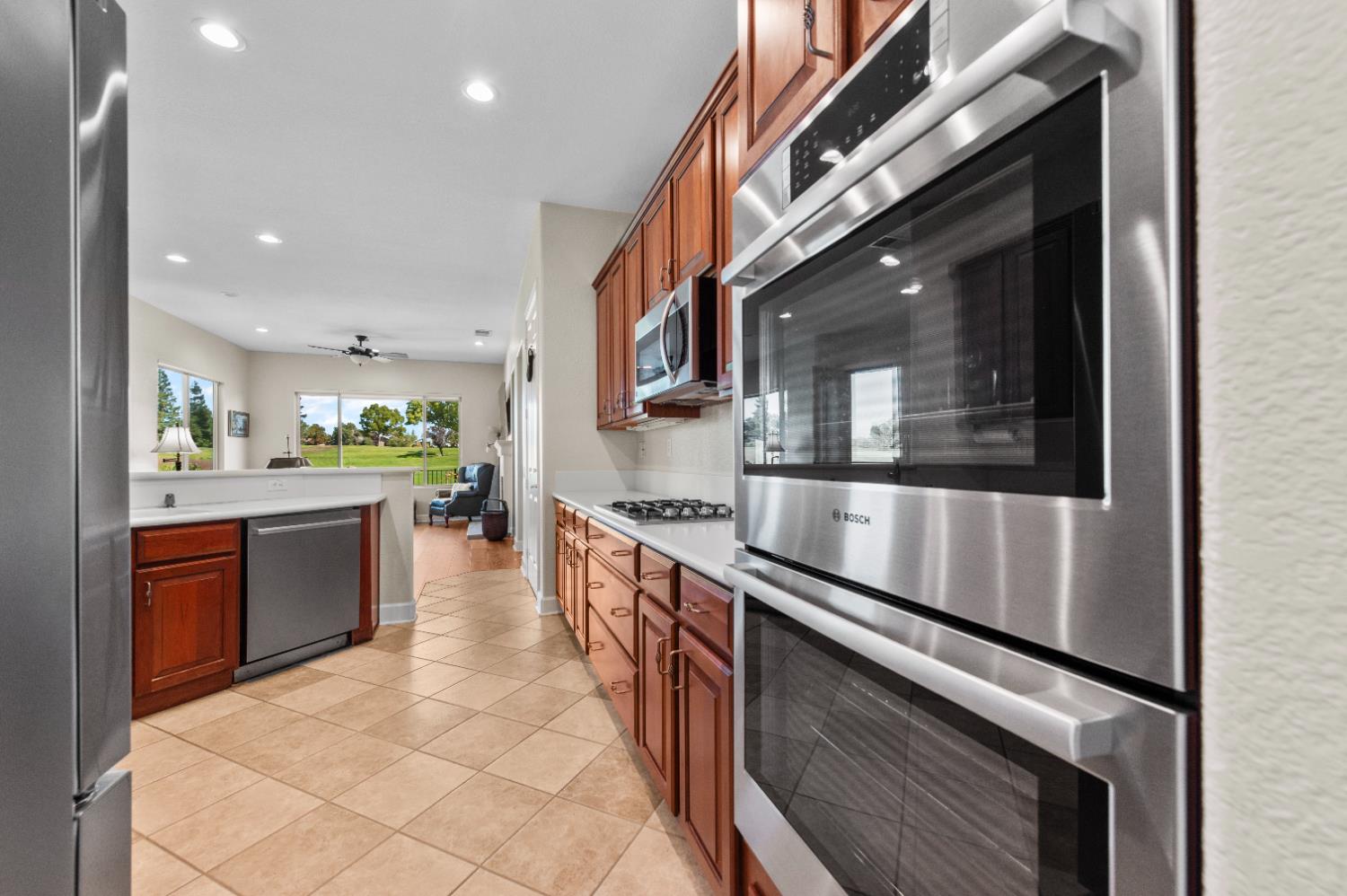 1146 Secret Lake Loop Lincoln, CA 95648 - Photo 29 of 61 a large kitchen with stainless steel appliances and large windows