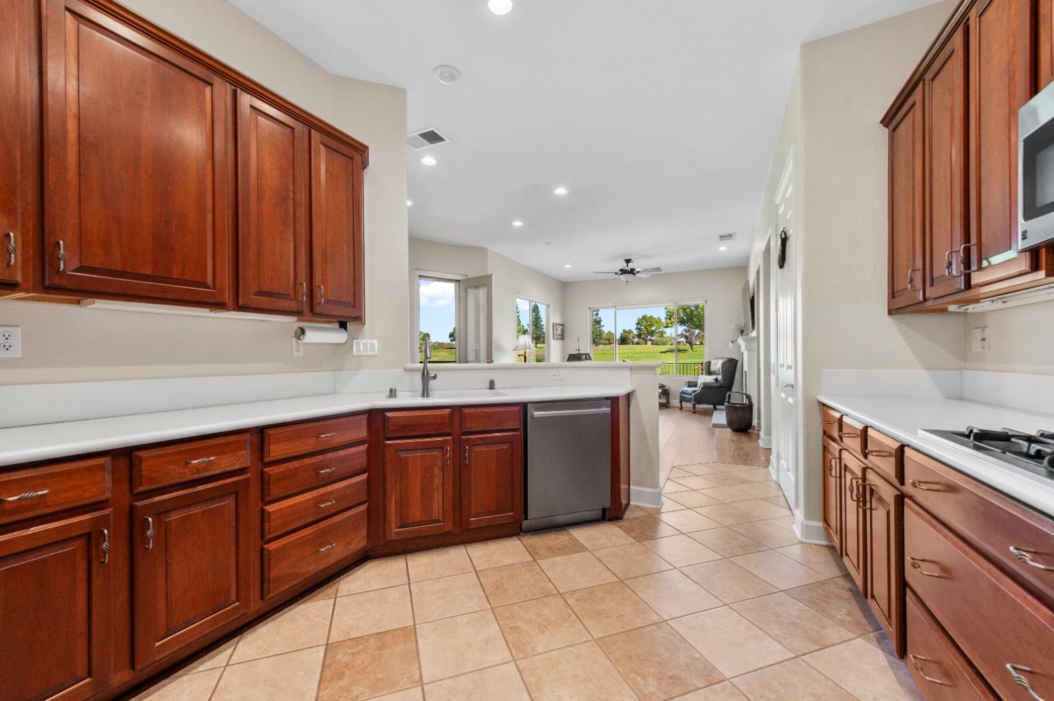 1146 Secret Lake Loop Lincoln, CA 95648 - Photo 30 of 61 a large kitchen with stainless steel appliances granite countertop a sink dishwasher stove and cabinets