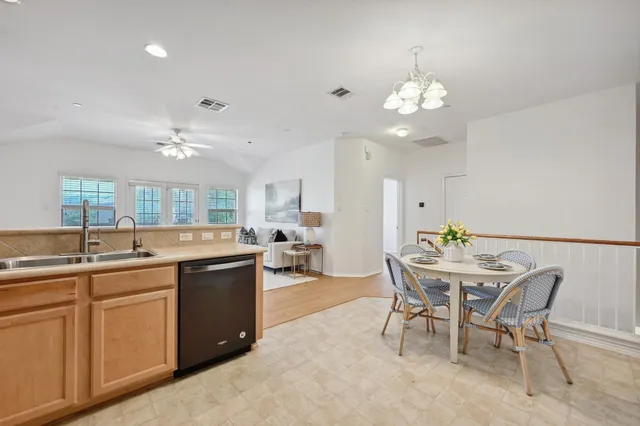 a view of a dining room with furniture and chandelier