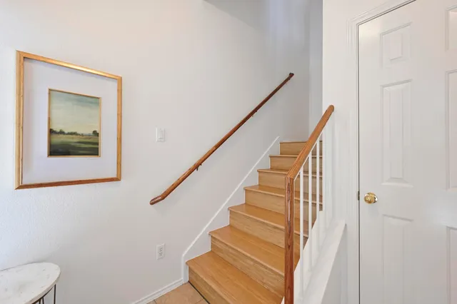 a view of entryway and hall with wooden floor