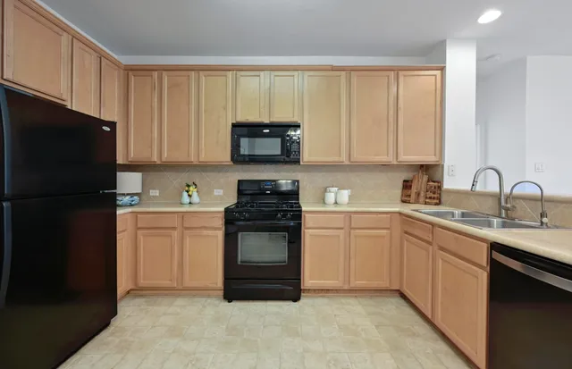 a kitchen with a sink stove and refrigerator