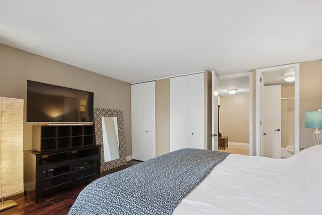 a bedroom with a bed and cabinets