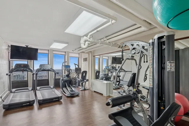 a large white kitchen with a large window appliances and cabinets