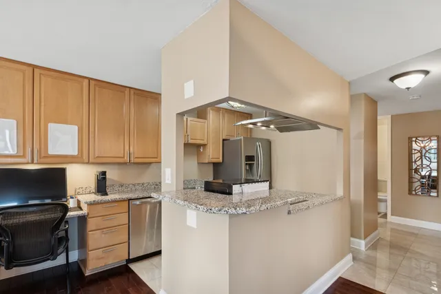 a kitchen with kitchen island granite countertop a stove and a sink