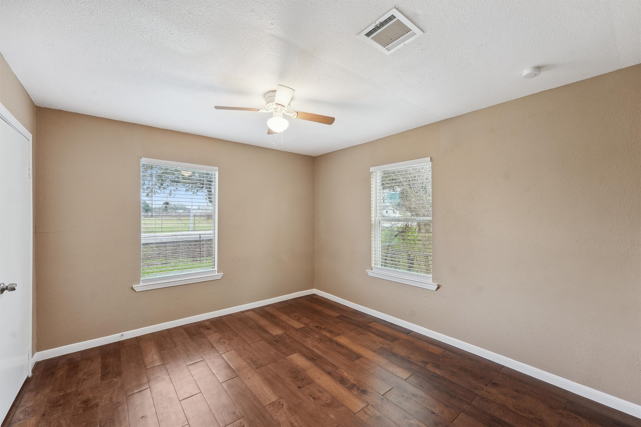 1107 Defender Street Houston, TX 77029 - Photo 12 of 26 a view of an empty room with a window and wooden floor