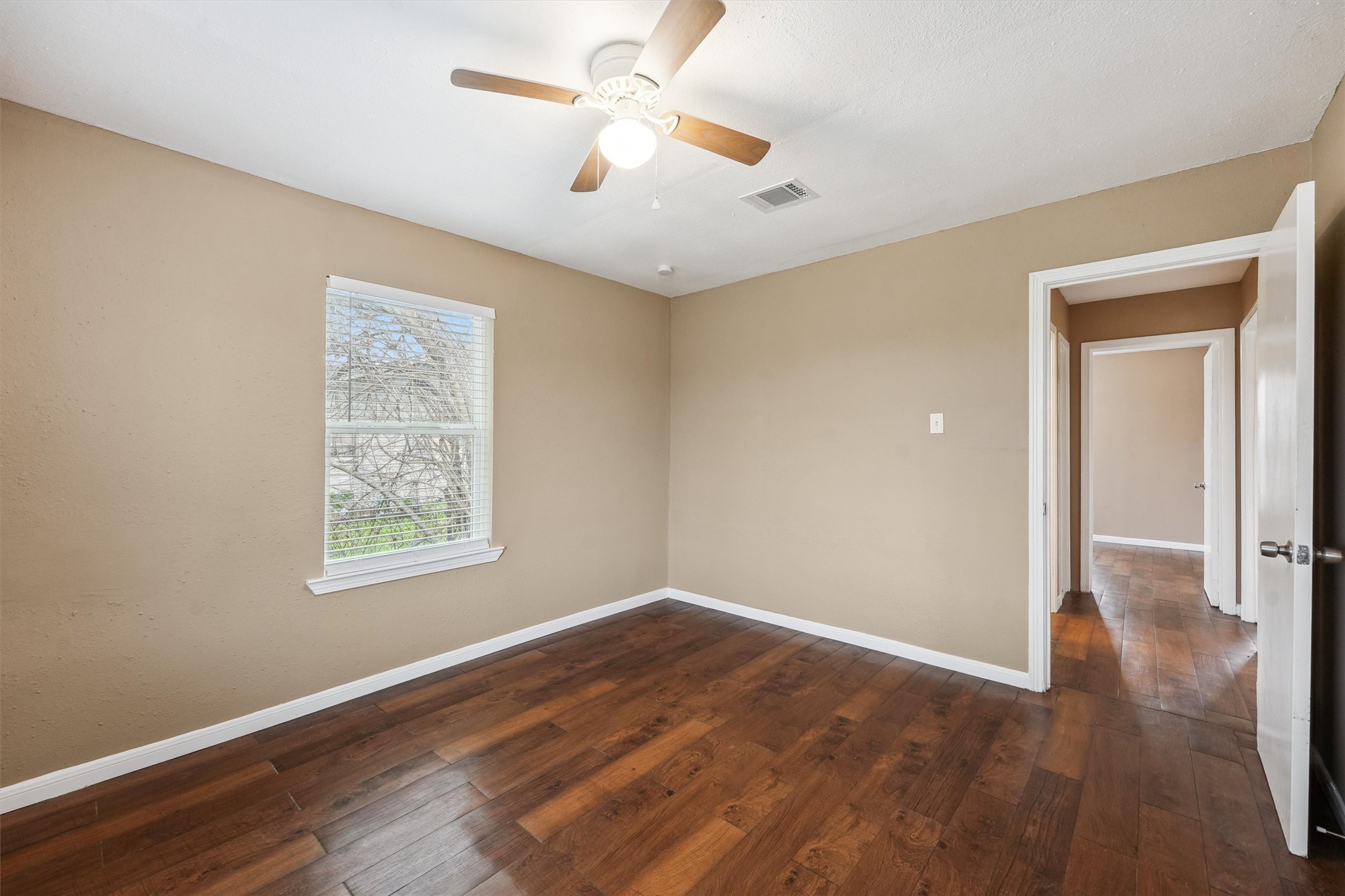 1107 Defender Street Houston, TX 77029 - Photo 14 of 26 a view of an empty room with wooden floor and a window