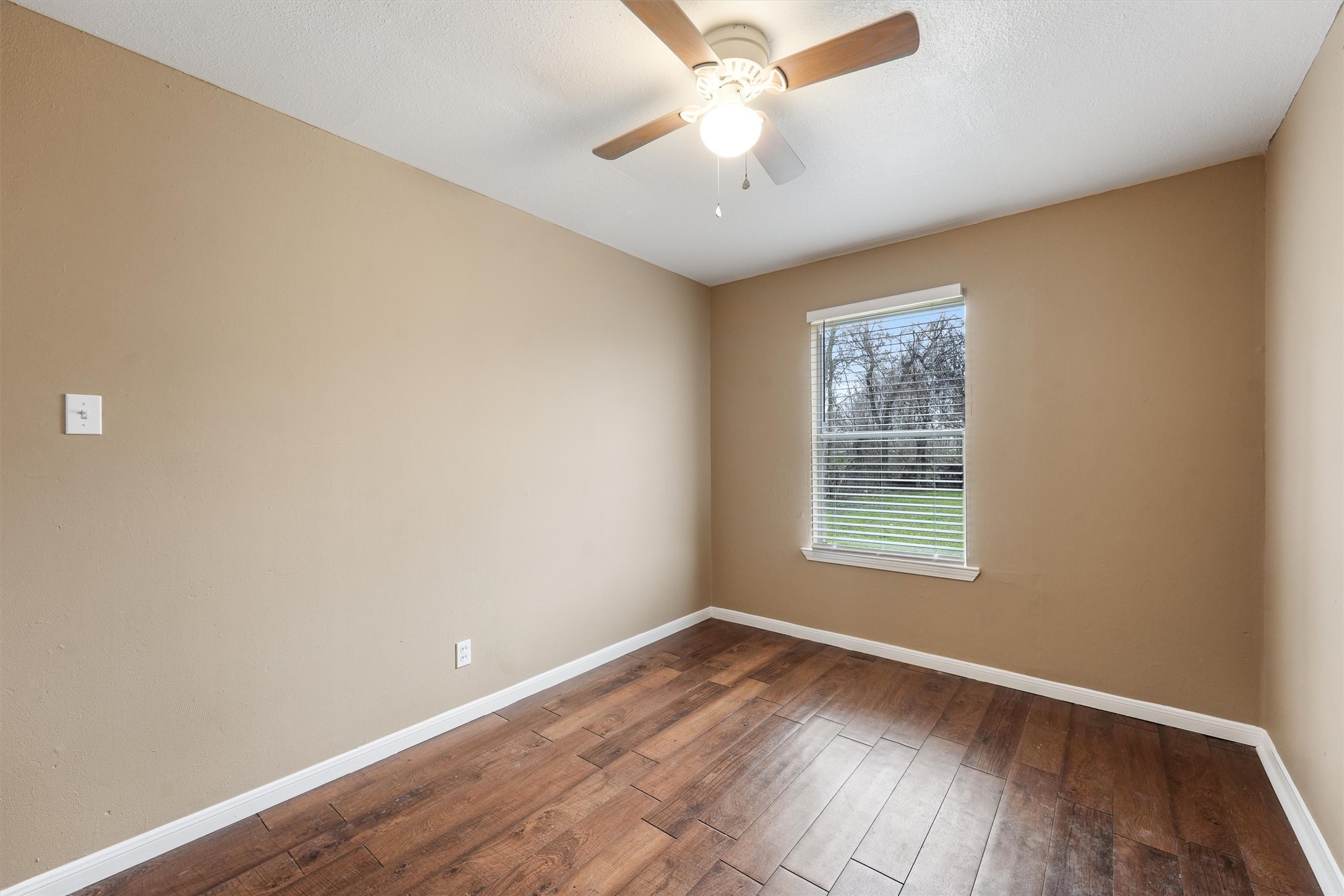 1107 Defender Street Houston, TX 77029 - Photo 16 of 26 an empty room with wooden floor and windows