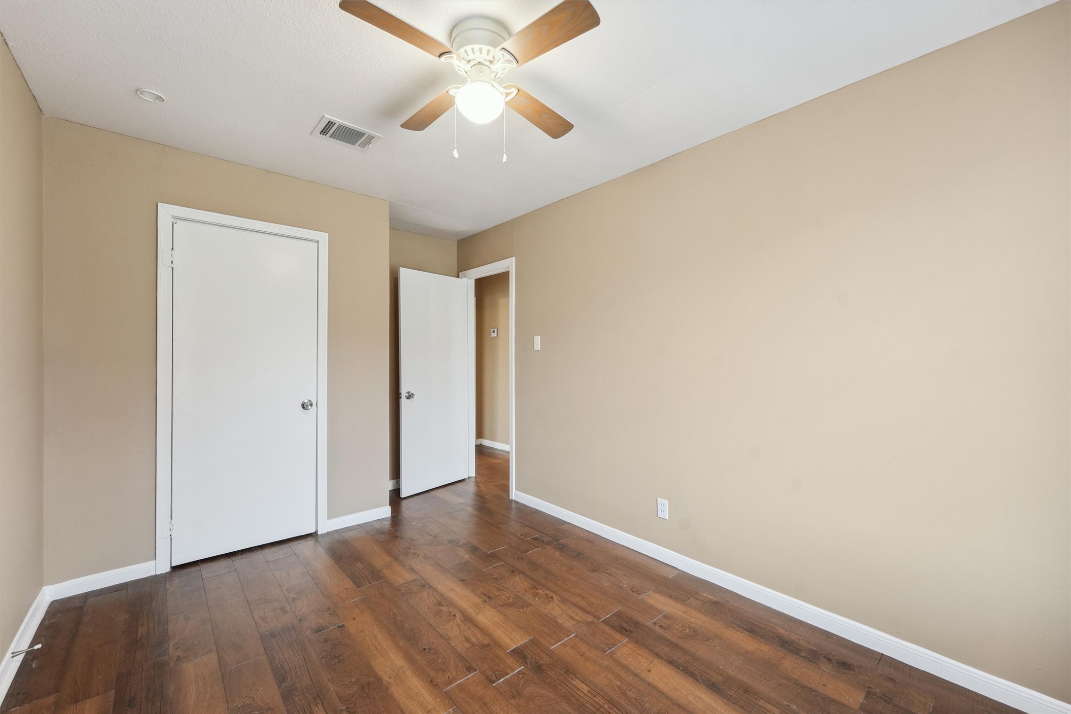 1107 Defender Street Houston, TX 77029 - Photo 17 of 26 an empty room with a ceiling fan and a window