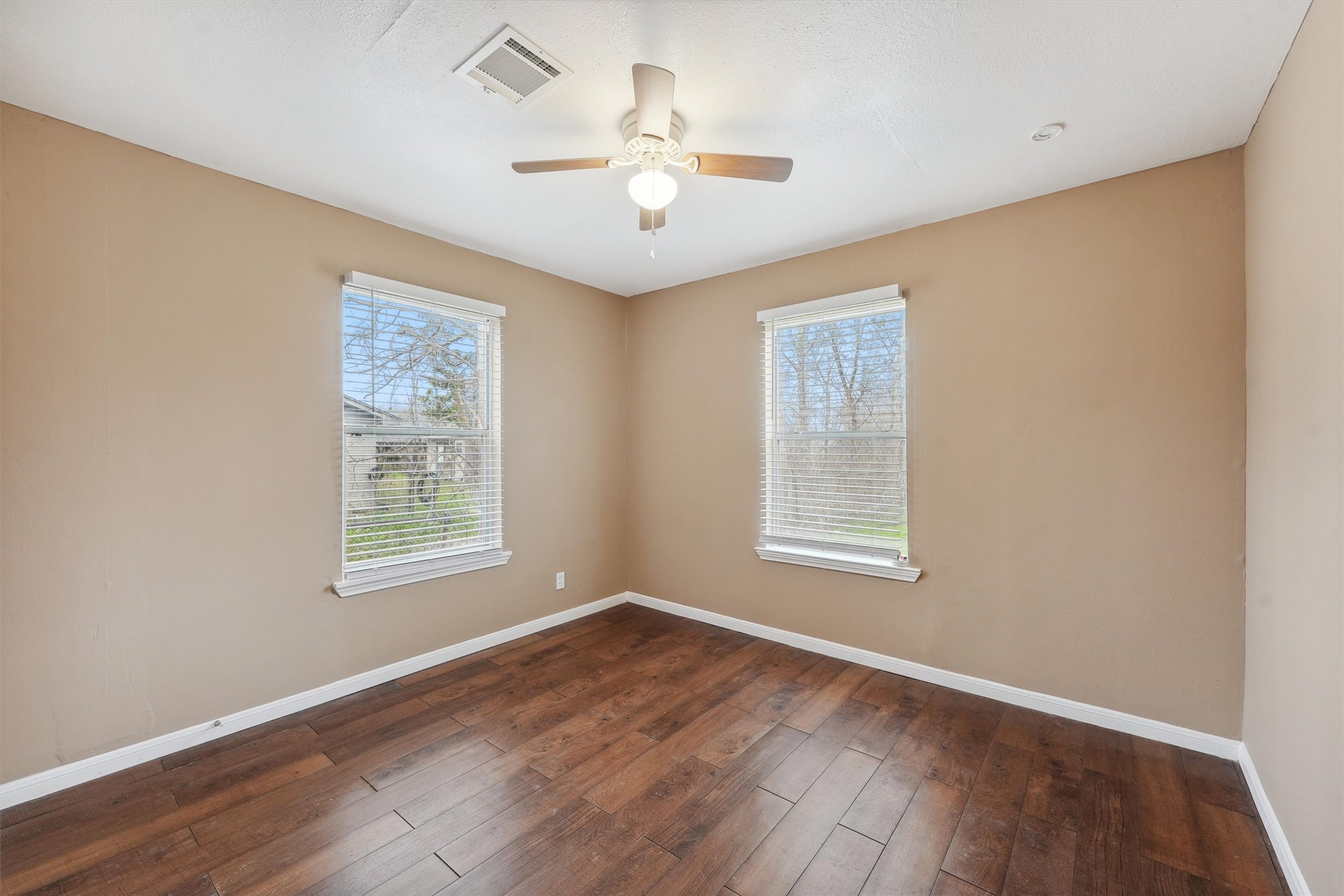 1107 Defender Street Houston, TX 77029 - Photo 19 of 26 a view of an empty room with wooden floor and a window