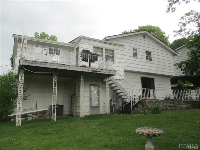 a front view of a house with a garden and plants