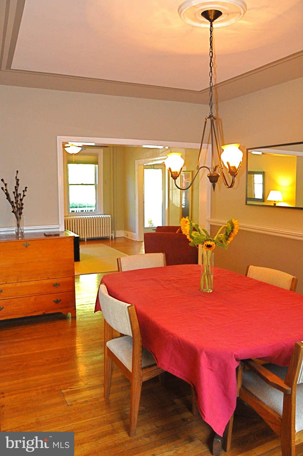 3825 Keswick Road Baltimore, MD 21211 - Photo 6 of 30 a view of a dining room with furniture and a chandelier