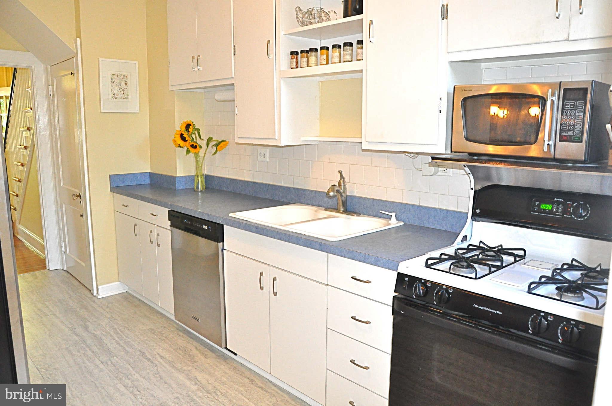 3825 Keswick Road Baltimore, MD 21211 - Photo 7 of 30 a kitchen with a sink stove and cabinets