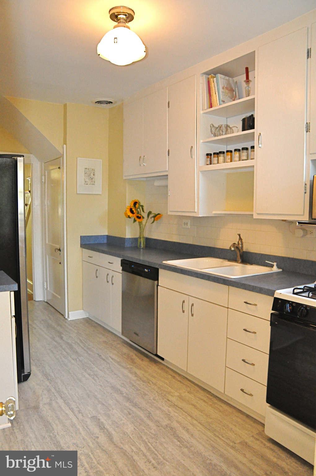 3825 Keswick Road Baltimore, MD 21211 - Photo 10 of 30 a kitchen with stainless steel appliances granite countertop a sink and cabinets