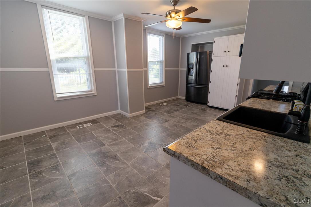 6366 Farm Bureau Road Allentown, PA 18106 - Photo 12 of 36 a view of a kitchen with a sink cabinet and a window