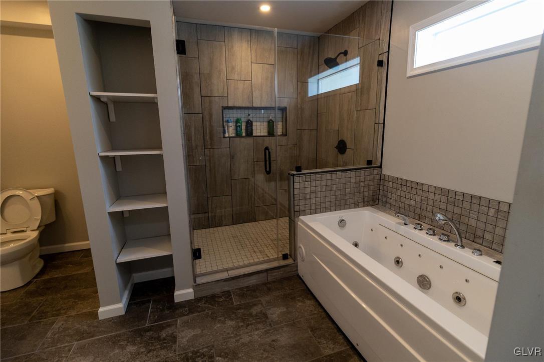 6366 Farm Bureau Road Allentown, PA 18106 - Photo 18 of 36 a bathroom with a tub a toilet and a shower