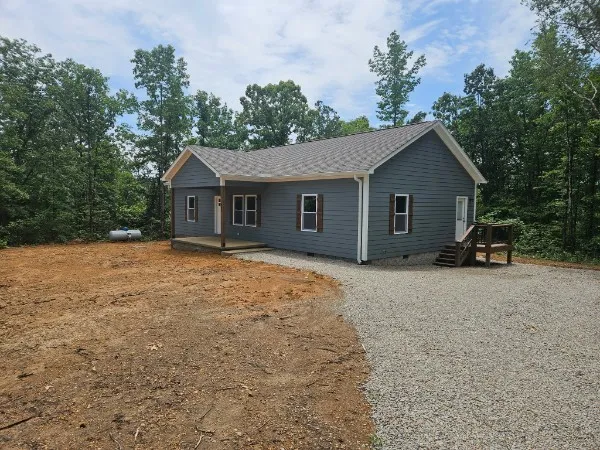 a front view of a house with a garden