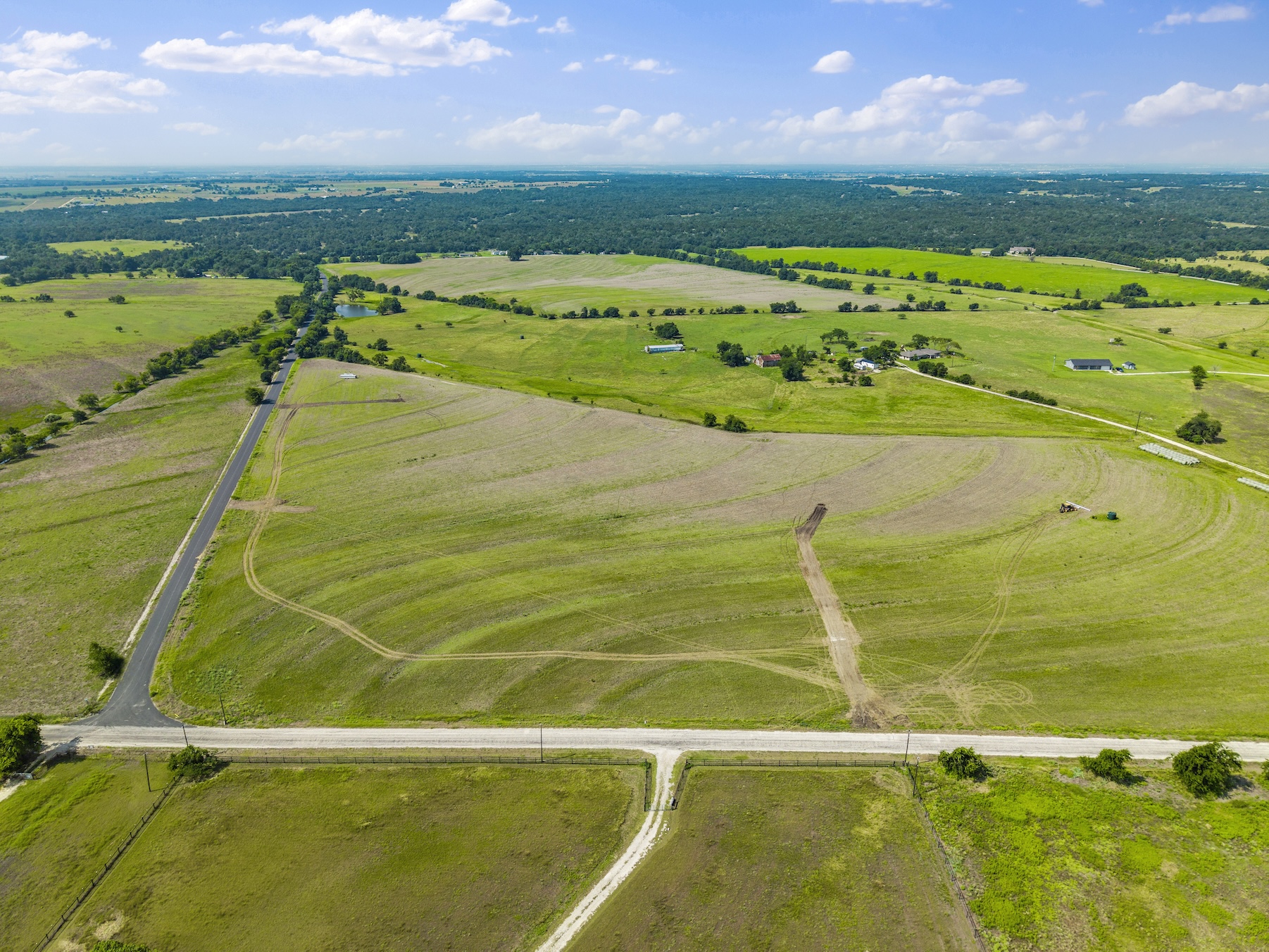 1 County Road 327 Road Granger, TX 76530 - Photo 19 of 27 Vast green pastures and rolling terrain stretch toward the horizon under a bright sky.