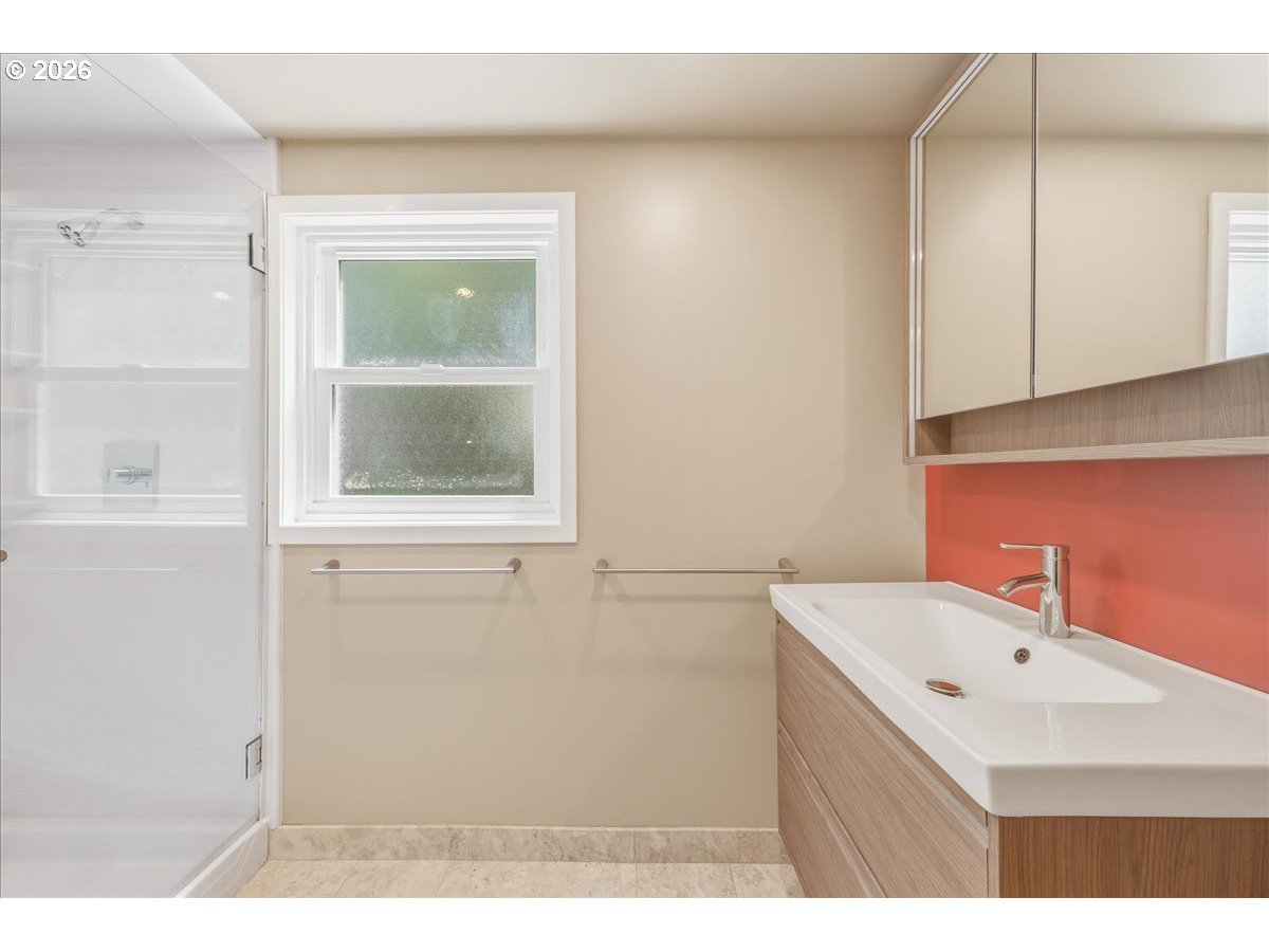 3130 Southwest 116th Avenue Beaverton, OR 97005 - Photo 30 of 44 a bathroom with a sink a mirror and a window