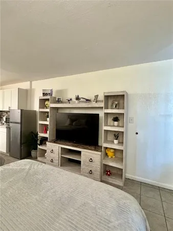 a living room with a flat screen tv and gym equipment