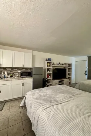 a large white bed in a white room