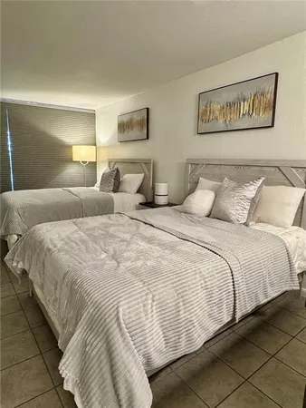 a bedroom with double bed and a couch