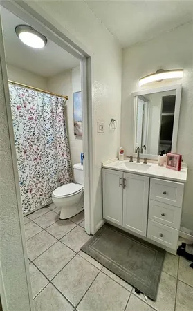 a bathroom with a double vanity sink toilet and shower