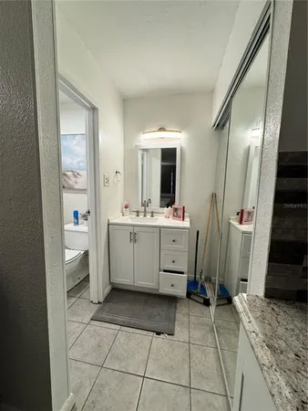 a bathroom with a sink a mirror and a toilet