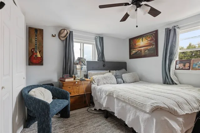 a bedroom with double bed and a chandelier