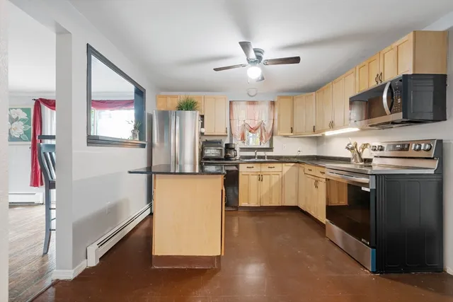 a kitchen with stainless steel appliances a refrigerator sink and microwave
