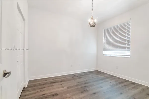 a view of a room with wooden floor and window